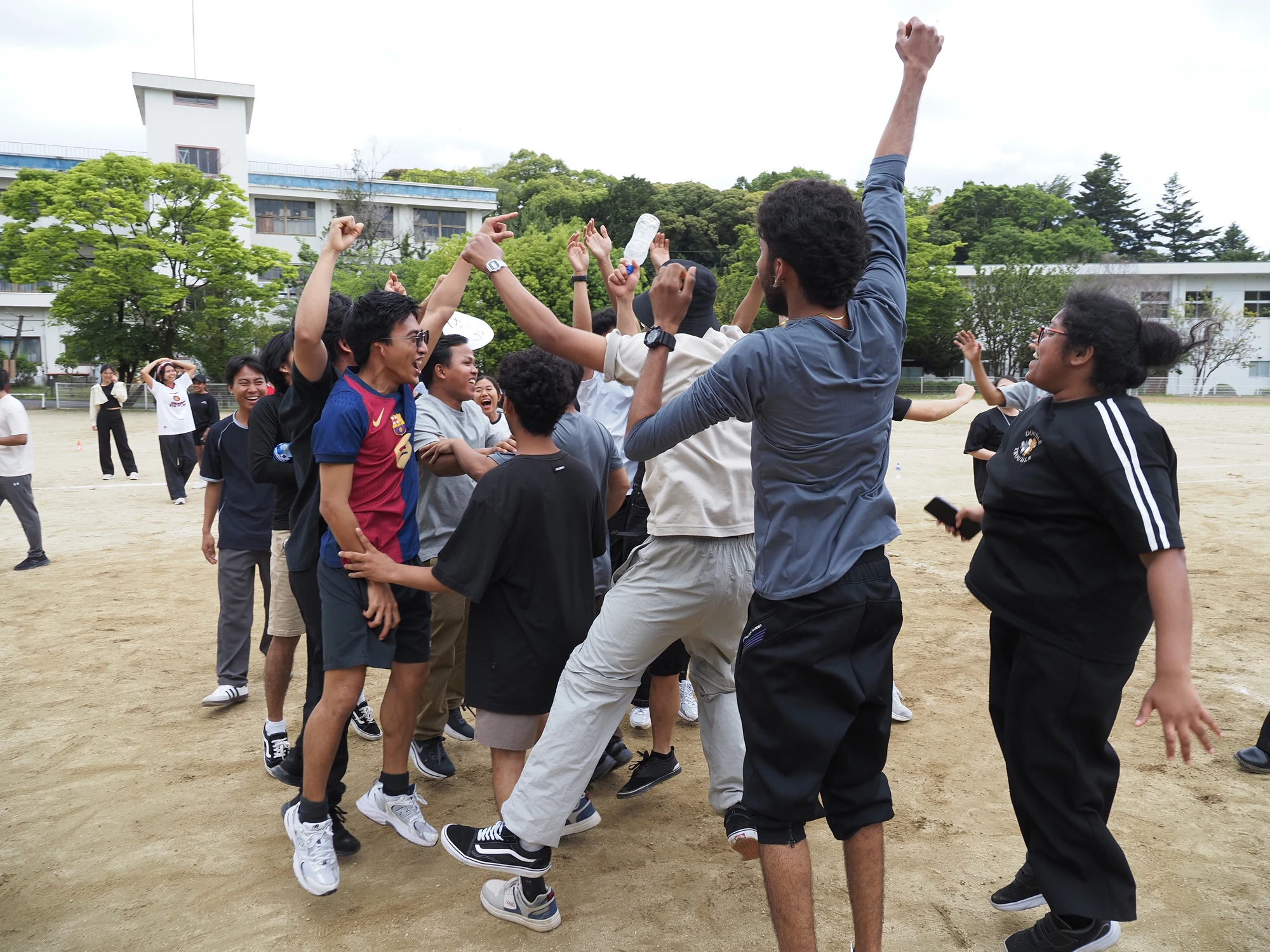 校庭で仲間とスポーツを楽しむ学生たち
